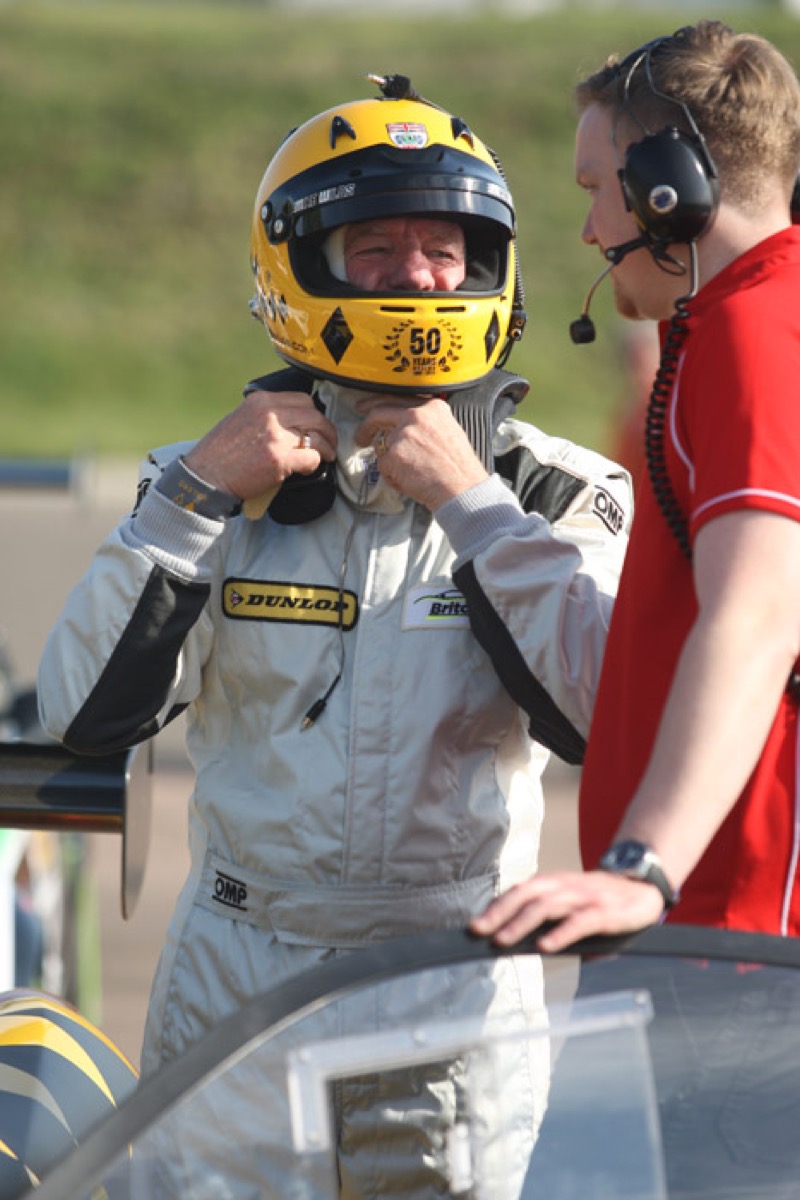 Racing driver preparing helmet